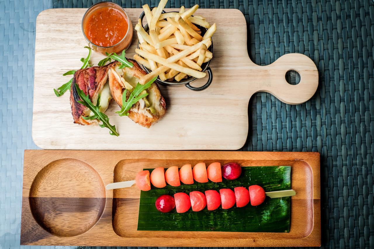 Fusion Suites Phuket Patong Buitenkant foto A wooden cutting board with a handle